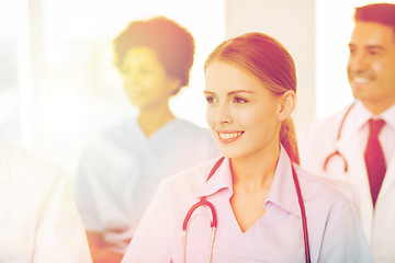 Image showing happy doctor over group of medics at hospital