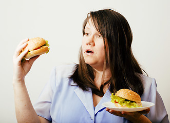 Image showing fat white woman having choice between hamburger and salad close 