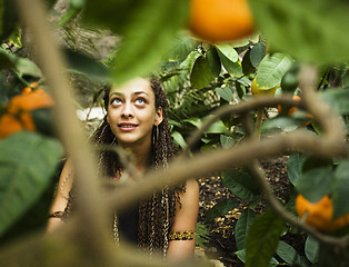 Image showing Young cute smiling woman in park with oranges