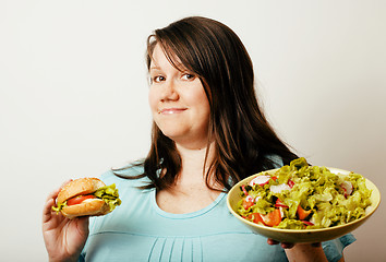 Image showing fat white woman having choice between hamburger and salad close 