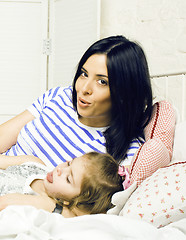 Image showing portrait of happy real mother and her daughter playing in bad, l