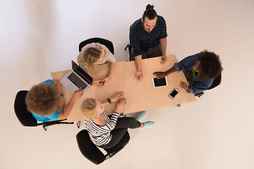 Image showing Multiethnic startup business team on meeting  top view