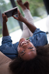 Image showing african american woman at home with digital tablet