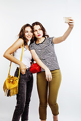 Image showing two best friends teenage girls together having fun, posing emotional on white background, besties happy smiling, making selfie, lifestyle people concept