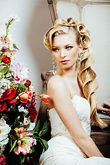 Image showing beauty young bride alone in luxury vintage interior with a lot of flowers close up