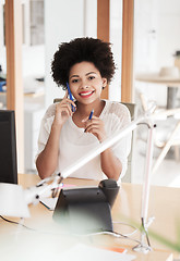 Image showing businesswoman calling on smartphone at office