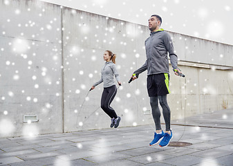 Image showing man and woman exercising with jump-rope outdoors