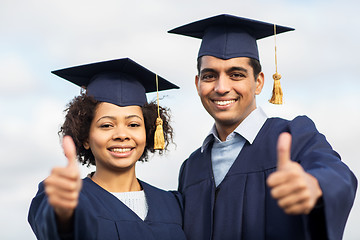 Image showing happy students or bachelors showing thumbs up