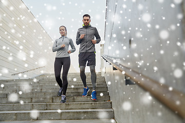 Image showing couple of sportsmen running downstairs outdoors