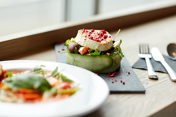 Image showing goat cheese salad and gazpacho soup at restaurant