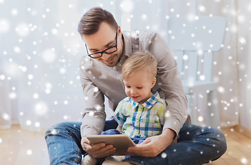 Image showing father and son with tablet pc playing at home