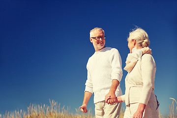 Image showing happy senior couple talking outdoors