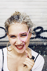 Image showing young pretty party girl smiling covered with glitter tinsel, fas