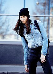 Image showing young pretty girl near business building walking