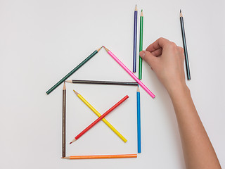 Image showing Women\'s hands are doing at the house of the tube pencils