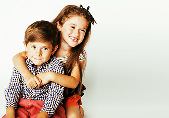 Image showing little cute boy and girl hugging playing on white background, ha