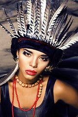 Image showing young pretty woman with make up like red indian, futher in hair,