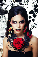 Image showing pretty brunette woman with rose jewelry, black and red, bright m