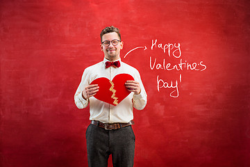 Image showing Young funny man with abstract broken heart