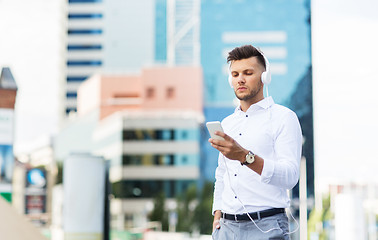 Image showing man with headphones and smartphone listening music