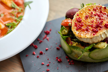 Image showing goat cheese salad with vegetables at restaurant