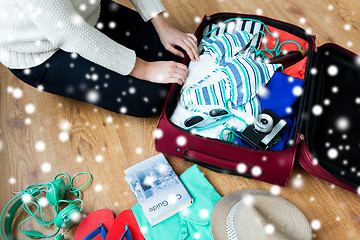 Image showing close up of woman packing travel bag for vacation