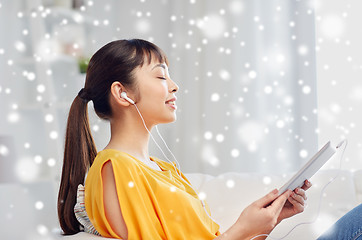 Image showing happy asian woman with tablet pc and earphones