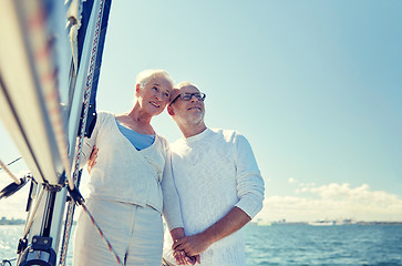 Image showing senior couple hugging on sail boat or yacht in sea