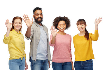 Image showing international group of happy people waving hands
