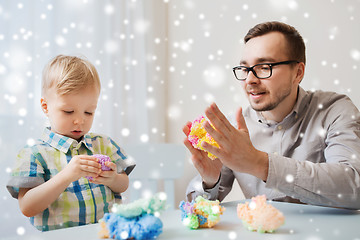 Image showing father and son playing with ball clay at home