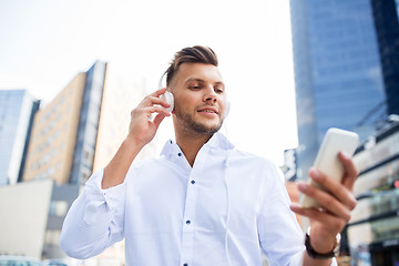 Image showing man with headphones and smartphone listening music