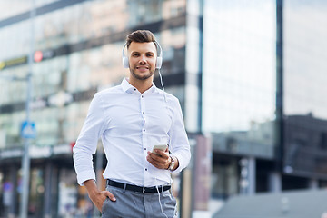 Image showing man with headphones and smartphone listening music