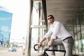 Image showing man with bicycle and headphones on city street
