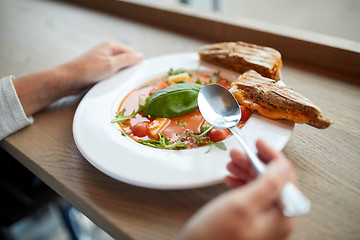 Image showing woman eating gazpacho soup at restaurant