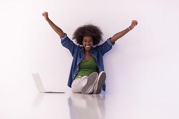 Image showing african american woman sitting on floor with laptop