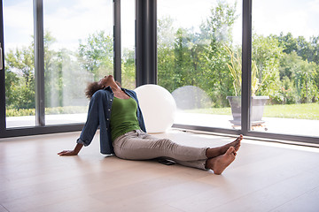 Image showing african american  woman  sitting near window