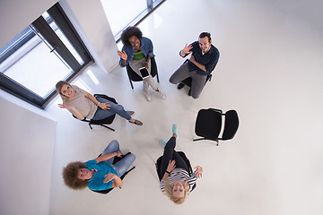 Image showing Multiethnic startup business team on meeting  top view