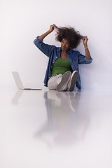 Image showing african american woman sitting on floor with laptop