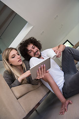 Image showing couple relaxing at  home with tablet computers