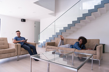 Image showing young multiethnic couple relaxes in the living room