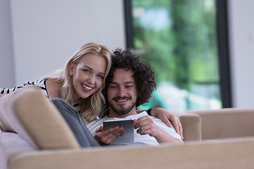 Image showing couple relaxing at  home with tablet computers