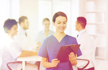 Image showing happy doctor over group of medics at hospital