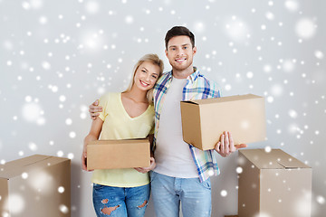 Image showing smiling couple with boxes moving to new home