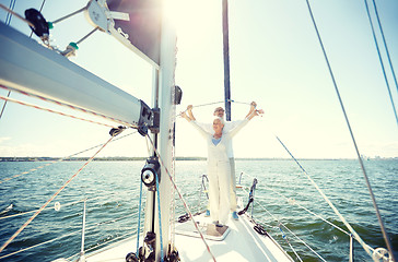 Image showing senior couple hugging on sail boat or yacht in sea