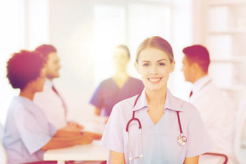 Image showing happy doctor over group of medics at hospital