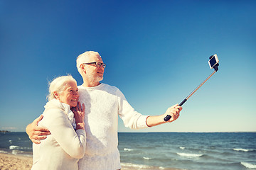 Image showing seniors with smartphone taking selfie on beach