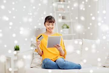 Image showing happy asian woman with tablet pc and credit card