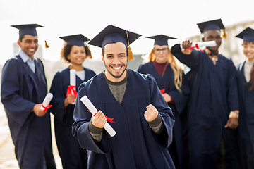 Image showing happy student with diploma celebrating graduation