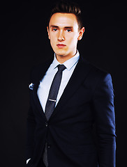 Image showing young pretty business man standing on black background, modern h