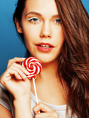 Image showing young pretty adorable woman with candy close up like doll